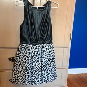 Leather (faux leather) and animal print.  Flared skirt with pockets.